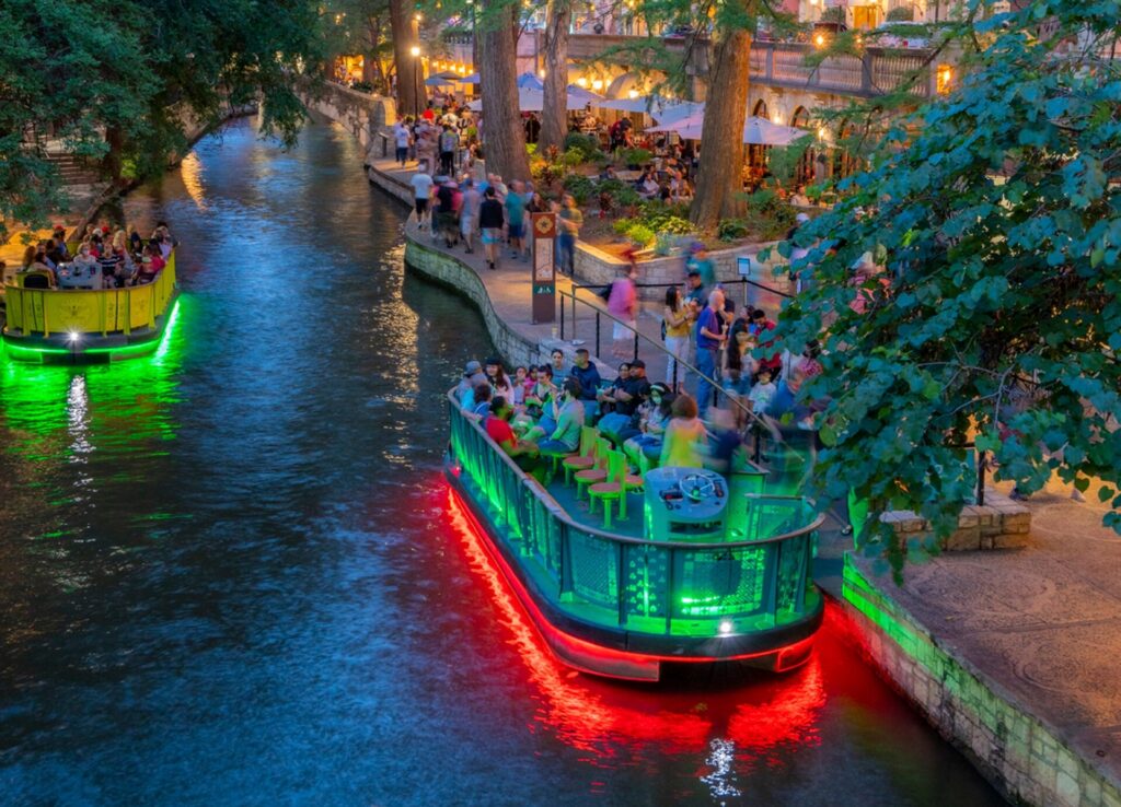 San Antonio River Walk Neon Light Barge Image By Visit San Antonio Photo by Al Rendon Owns Full rights edited e1789775271509