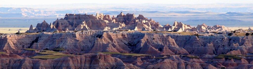 Badlands-at-sunset South Dakota with the stunning rock formations and layers of colours