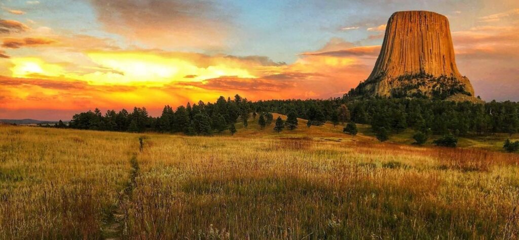 Devils Tower National Monument at sunset showing the path to the monument